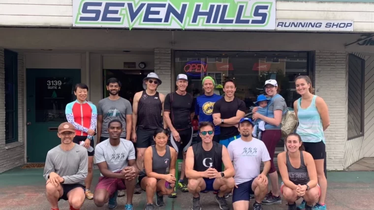 Group photo of the Seattle Green Lake Runners First Sunday Group Run from Seven Hills Running Shop posing outside of the store.