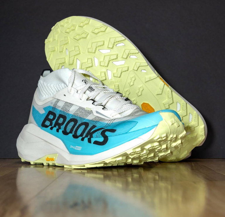 A new pair of Brooks Cascadia Elite trail running shoes photographed against a black background.