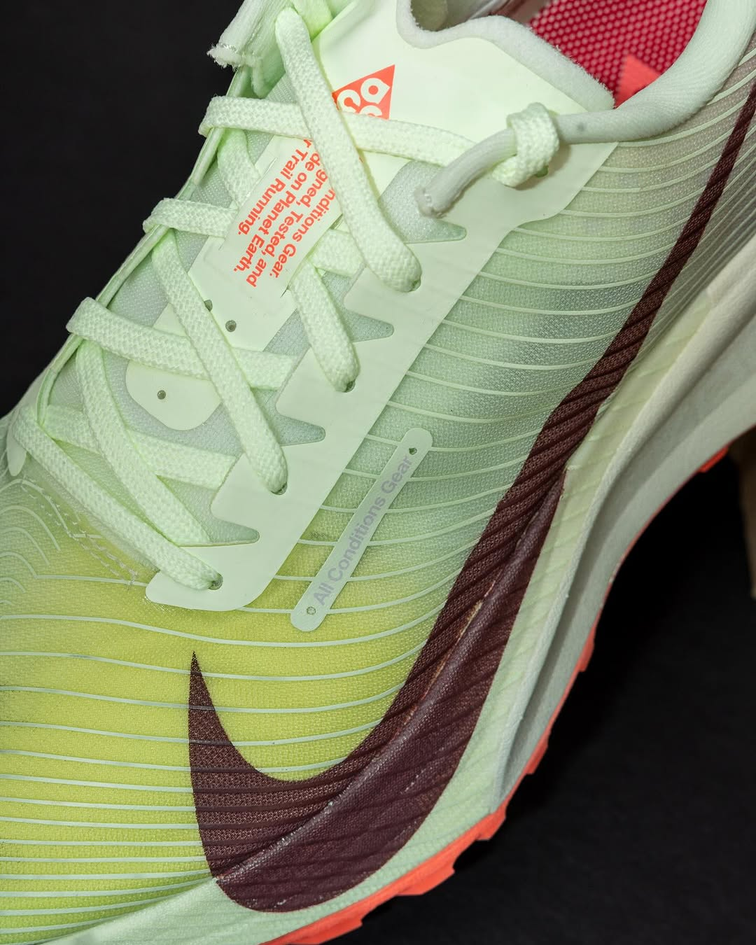 Close up image of the Nike ACG Ultrafly Trail trail racing shoe showing the Nike swoosh on the side and the ACG branding on the tongue beneath the laces.