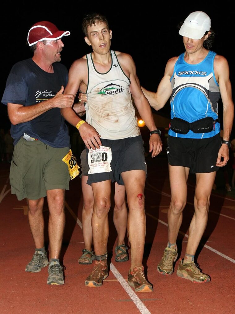 An exhausted Brian Morrison is helped by his crew. WS100 2006