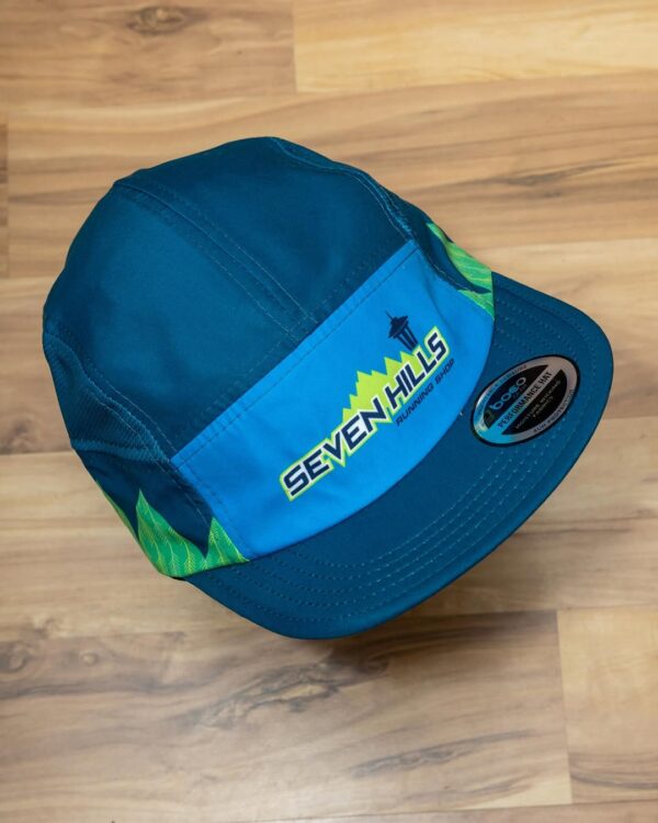 A blue and green Seven Hills Running Shop sublimated performance running cap from Boco Gear.