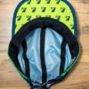 Underside of a Seven Hills Running Shop running hat showing the under-brim with a pattern of Team7Hills logo 7s.